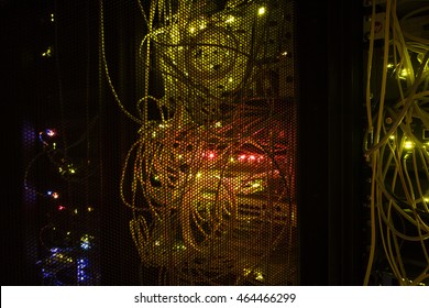 Selective focus. Operating network equipment in the server room. Processing the data stream on the optical channel. Data center in the dark. 