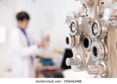 Selective focus at Optometry frame equipment. With blurred background while optometrist examine eye visual system of elder patient women with professional machine before made glasses. 