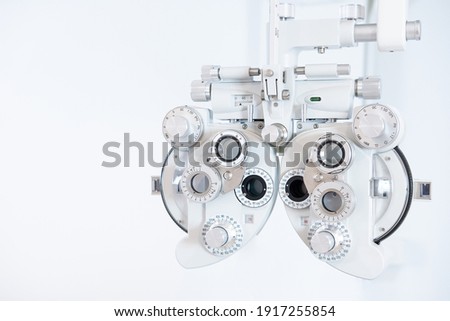 Selective focus at Optometry frame equipment. With blurred white background for copy space. Optometrist tool to examine eye visual system of patient with professional machine before made glasses. 