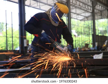 Selective Focus The Orange Grinding Fire Platter , Metal Grinding Process, Metal Worker Use Electric Wheel Grinding On Steel Structure In Factory