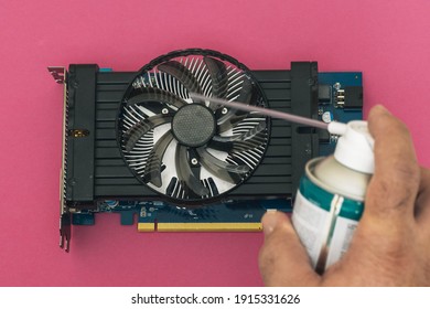 Selective Focus Of A Pc Graphics Card Being Cleaned With A Can Of Cold Compressed Air