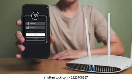 Selective Focus At People Hand While Using Smartphone To Type Password Credential To Login To Internet Wireless Connection At Home. Network Security Of Internet Access Into Router With Futuristic Icon