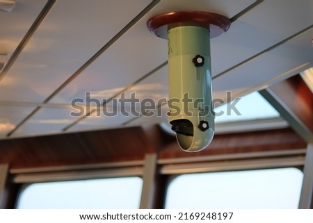 selective focus periscope which is in the ship control rudder of the supply ship bridge which functions to view the magnetic compass vintage interior of a ship and has a vital function in an emergency