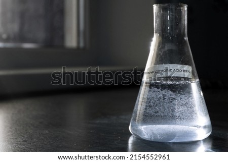 Selective focus of Phosphoric acid 85% solution in glass flask. High quality photo