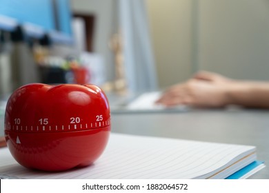 A selective focus of the Pomodoro timer on a noteboo