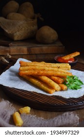 Selective Focus Of Potato Cheese Stick On A Wooden Coaster In Dark Background 