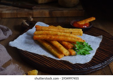 Selective Focus Of Potato Cheese Stick On A Wooden Coaster In Dark Background 