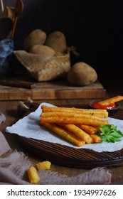 Selective Focus Of Potato Cheese Stick On A Wooden Coaster In Dark Background 