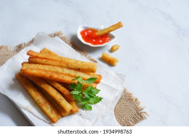 Selective Focus Of Potato Cheese Stick In A Wooden Coaster Against White Background