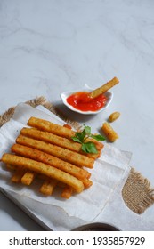 Selective Focus Of Potato Cheese Stick In A Wooden Coaster Against White Background