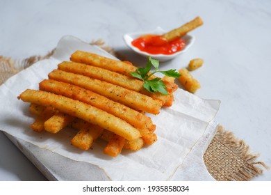 Selective Focus Of Potato Cheese Stick In A Wooden Coaster Against White Background