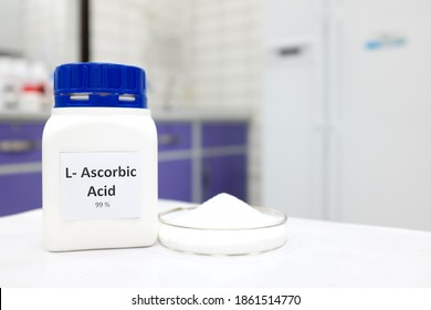 Selective Focus Of Pure Vitamin C Or Ascorbic Acid Bottle Beside A Petri Dish With White Crystalline Powder In A Chemistry Laboratory Background.