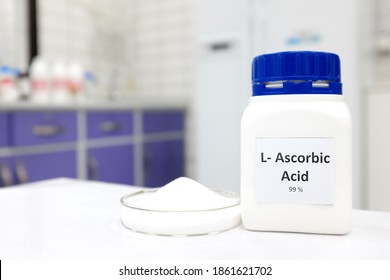 Selective Focus Of Pure Vitamin C Or Ascorbic Acid Bottle Beside A Petri Dish With White Crystalline Powder In A Chemistry Laboratory Background.