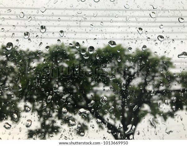 Selective focus of rain drop on car\'s window in\
raining day it\'s make traffic jam in the morning. Feeling lonely\
when see the rain drop\
alone.