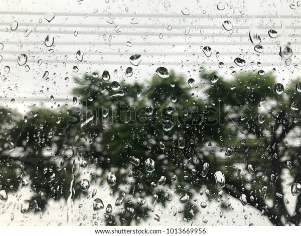 Selective focus of rain drop on car\'s window in\
raining day it\'s make traffic jam in the morning. Feeling lonely\
when see the rain drop\
alone.
