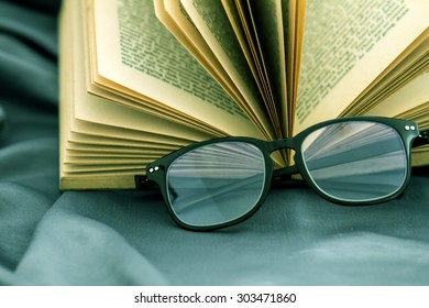 selective focus of  the reading Eyeglasses with opened book
