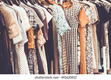 Selective focus retro clothes of different colors on hanger , retro tone picture
