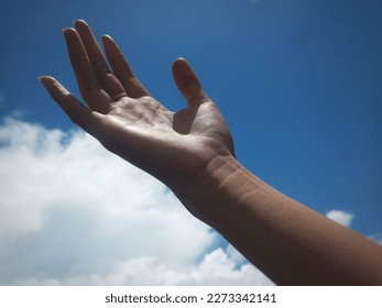 Selective Focus of Right Hand Stretched Out Towards the Sky