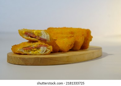 Selective Focus Risoles Sosis Mayo (American Risoles) Or Mayonnaise Sausage Rissole Is A Small Patty Rolled In Breadcrumbs. It Is Filled With Mayonnaise, Boiled Egg And Sausage. Served On White Plate.