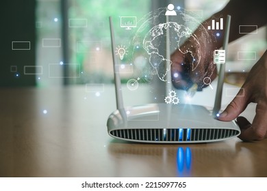 Selective focus at router. Internet router on working table with blurred man connect the cable at the background. Fast and high speed internet connection from fiber line with futuristic icon - Shutterstock ID 2215097765