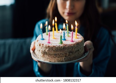 Selective Focus Of Sad Woman Holding Birthday Cake With Candles