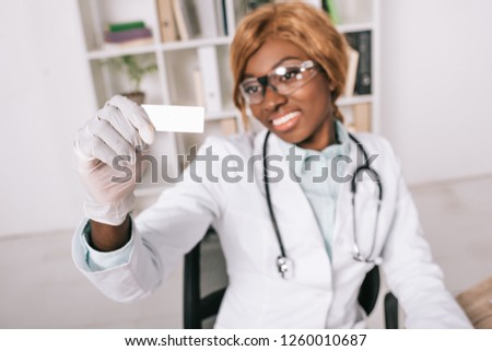 selective focus of sample in hand of female african american scientist 