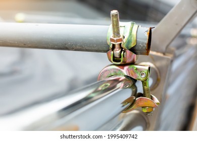 Selective focus to scaffolding pipe clamp and parts, An important part of building strength to scaffold clamps in used close up on construction site.