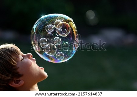 Similar – Image, Stock Photo Nu blow times fast ! (Boy portrait with soap bubbles, detail)