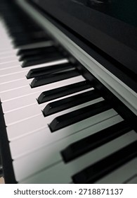 A selective focus shot captures the elegant perspective of musical instrument keys in a rhythmic pattern. The composition emphasizes the contrast between the ivory and ebony surfaces of the synthesizer or electronic piano