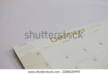 Selective focus shot of a closeup calendar of December 2023. December 2023 calendar isolated on background. 