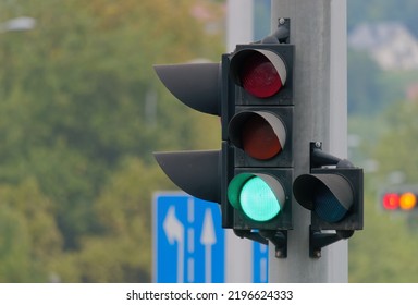 Selective Focus Shot Of A Green Traffic Light On A Metal Pole