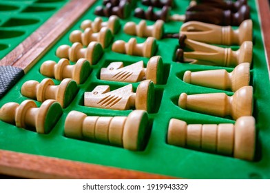 A Selective Focus Shot Of A Set Of Wooden Chess Pieces In A Green Box