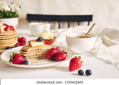 A selective focus shot of sliced vegan pancakes with fruits and syrup - Powered by Shutterstock