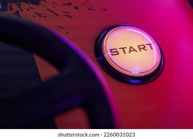 A selective focus shot of a start button of an arcade game