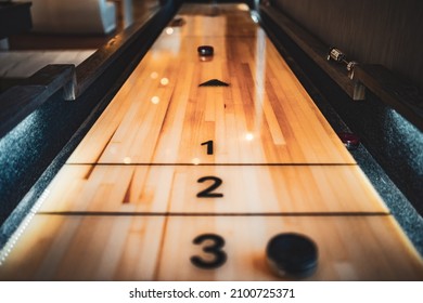 A selective focus shot of a table game of a shuffleboard