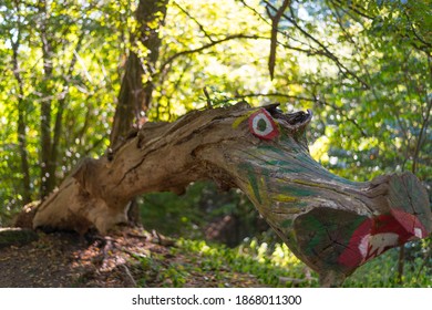 A selective focus shot of a tree trunk painted as a dragon