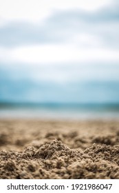 A selective focus shot of wet sand on the coast