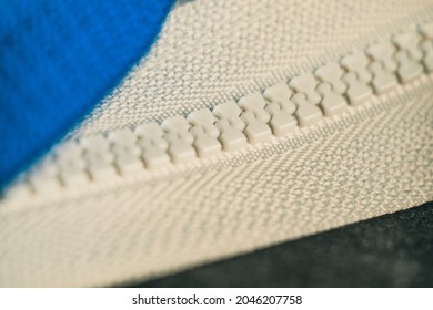 A Selective Focus Shot Of A White Zipper