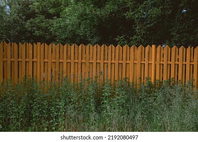 A Selective Focus Shot Of Wooden Fencing In A Field