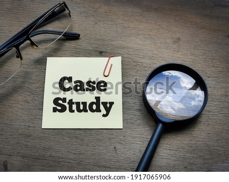 Selective focus side view text Case Study on sticky note with magnifying glass and eye glasses on wooden background.