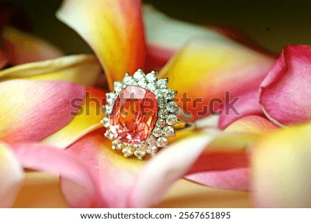 Selective focus silver ring with genuine mined natural orange sapphire gemstones oval shape cutting and diamond.