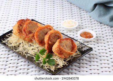 Selective Focus Slices Of Chicken Egg Rolls, Is Omelete Egg Stuffed With Ground Chicken And Spices, Steamed And Deep Fry, Served With Chili Mayonaise Sauce Above Crispy Vermicelli