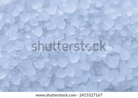 Selective focus of small ice balls (white hail) on the ground, The pellets of frozen rain which fall in showers from cumulonimbus clouds, Rain and hail in winter, Natural phenomenon, Nature background