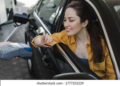 Selective Focus Of Smiling Woman Holding Credit In Card Near Worker Of Gas Station With Payment Terminal