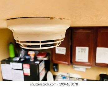 Selective focus of a smoke detector inside a break room kitchen.