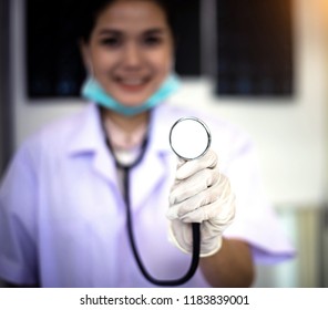 In Selective Focus Of The Stethopscope On Doctor Hand,warm Light Tone,blurry Light Design Background