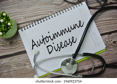 Selective focus of stethoscope, flower, spectacle and notebook written with AUTOIMMUNE DISEASE. It is a condition in which your immune system mistakenly attacks your body