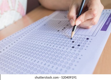 Selective Focus Student Filling Out Answers To A Test With A Pencil.