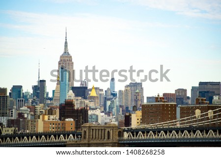 (Selective focus) Stunning view of the Manhattan Bridge and the beautiful skyline of New York seen from the Brooklyn bridge. Manhattan, New York City, USA.