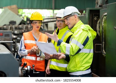 Selective Focus. Supervisor, Technician worker working in heavy Industry manufacturing factory on business day. Industrial engineers have to consult with colleagues. Workplace gender equality concept